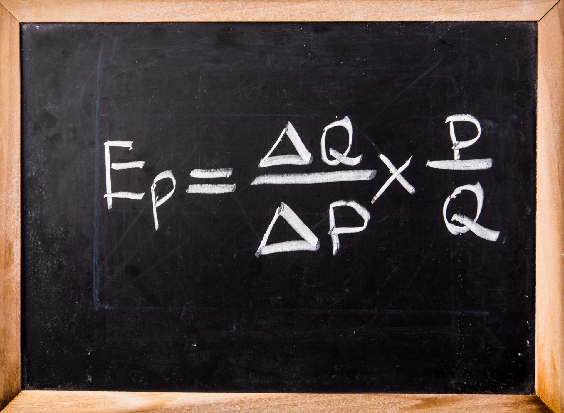 Een schoolbord met de formule voor prijselasticiteit van de vraag: Ep = (ΔQ / ΔP) × (P / Q), waarbij Ep de elasticiteit is, ΔQ de verandering in hoeveelheid aangeeft, ΔP de verandering in prijs aangeeft, P staat voor prijs en Q de hoeveelheid vertegenwoordigt.
